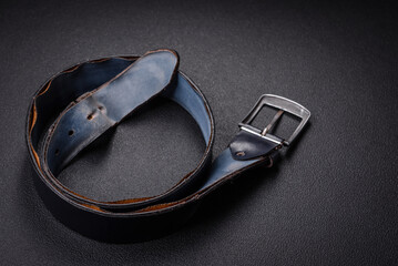 Old leather men's belt with an old-style metal buckle