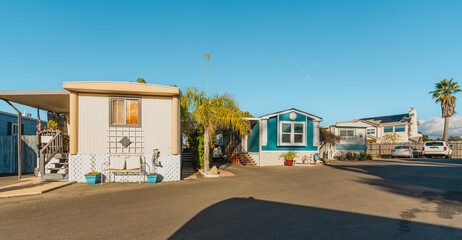 Mobile home park. A row of residential mobile park homes in a small town somewhere in California, street view. Lifestyle, architecture