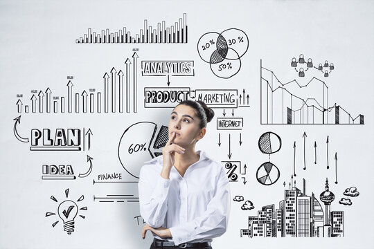 Businesswoman with thoughtful expression looking at strategy sketches and diagrams, business concept