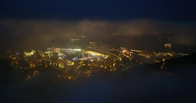 Aerial Panning Shot Of Gold Colored City Landscape In Sea At Tranquil Night - Monte Carlo, Monaco