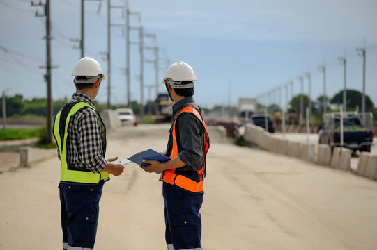 Highway engineers discuss plans for construction improvement based on roadworks. Soil Fill, Backfill Compaction for Sub base, Base Course, Surveyor Engineer inspector in highway construction.