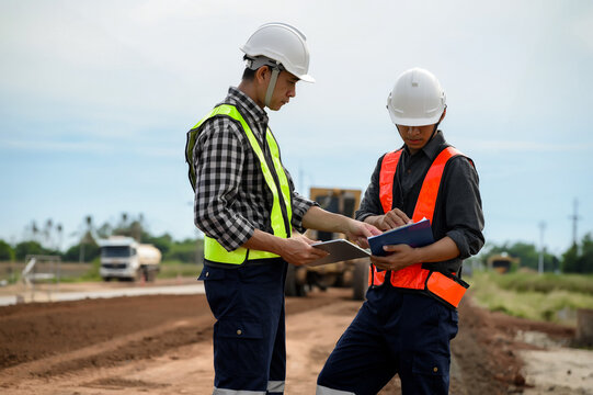 Highway engineers discuss plans for construction improvement based on roadworks. Soil Fill, Backfill Compaction for Sub base, Base Course, Surveyor Engineer inspector in highway construction.