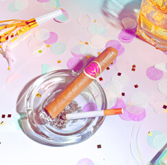 A Cigarette and a Cigar in an Ashtray and Confetti in an Morning After Party Scene