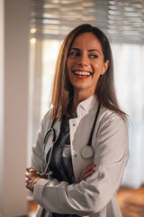 Portrait of a happy doctor at her workspace.