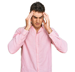 Naklejka premium Hispanic young man wearing casual clothes suffering from headache desperate and stressed because pain and migraine. hands on head.