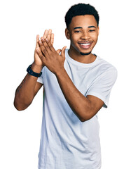 Young african american man wearing casual white t shirt clapping and applauding happy and joyful,...