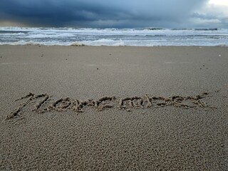 November als Wort im Strandsand