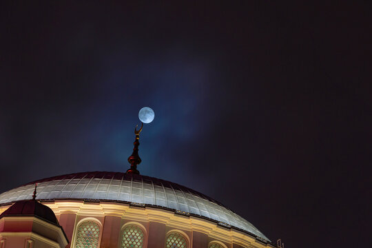 Islamic background photo. Full moon and a dome of a mosque