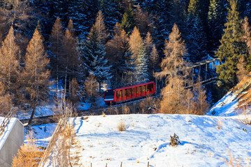 Red ski funicular in the Swiss Alps in winter resort Davos, Switzerland