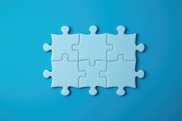 A group of white puzzle pieces on a blue background. Can be used for concepts related to problem-solving, teamwork, or puzzles
