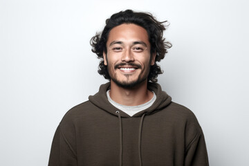 Obraz premium Man wearing brown hoodie smiles directly at camera. This image can be used to depict happiness, positivity, and casual fashion.