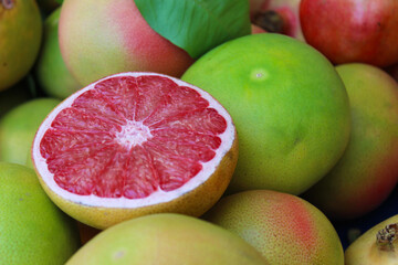 healthy food cut grapefruit on the background of green leaves and grapefruit fruits