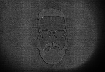 glass head with glasses and a beard on a fabric background