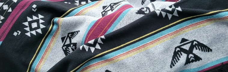 Colorful textile blanket with native thunderbird patterns