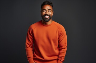Obraz premium a male in an orange jumper posing for a photo,