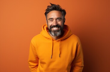 Obraz premium a male in an orange jumper posing for a photo,