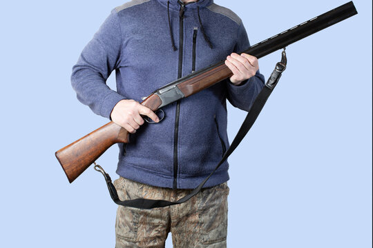 A hunter with a gun on a blue background.The sale of hunting weapons.