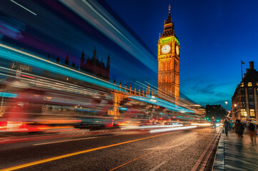 London Big Ben and Westminster Bridge with Palace of Westminster. Blurry people because of Long Exposure. Red bus in Motion