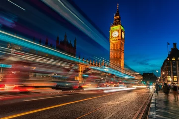 Fotobehang London Big Ben and Westminster Bridge with Palace of Westminster. Blurry people because of Long Exposure. Red bus in Motion © Mindaugas Dulinskas