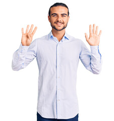 Young handsome man wearing business clothes showing and pointing up with fingers number nine while...