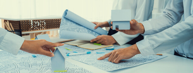 Worker, architect and engineer work on real estate construction project oratory planning with...