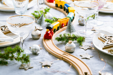 Festive Chriustmas place setting with small wooden railway