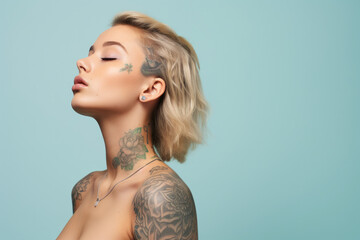 A woman with tattoos on her face and shoulder has her eyes closed