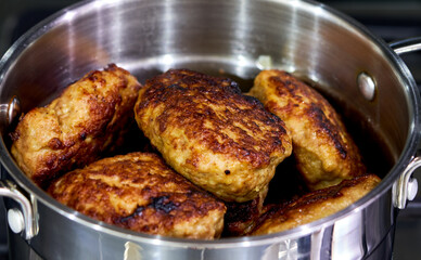 cutlets lie in a pan in the kitchen