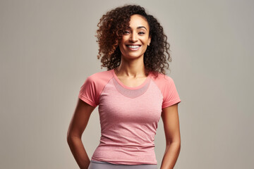 A woman with curly hair is wearing a pink shirt