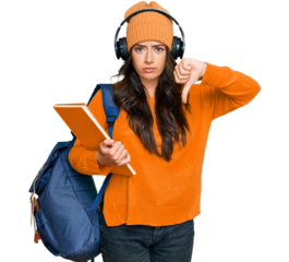 Beautiful brunette young woman wearing student backpack and holding books with angry face, negative sign showing dislike with thumbs down, rejection concept