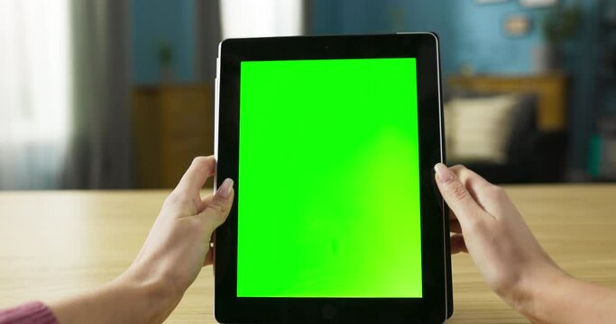 Digital artist illustrator, using tablet to create digital artwork or sketches. Her precise movements and occasional strokes on the screen reflect her artistic expression and talent.