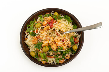 Pasta with seafood and vegetables in a bowl on a white background