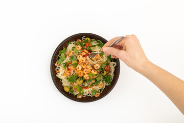 A person sticks a fork into pasta with seafood