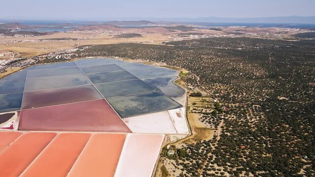 Aerial shot of produce extracting sea salt from saltern pond or open salt works evaporation ponds