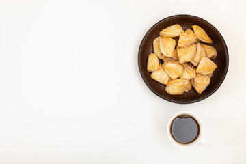 Homemade cookies in a bowl and a cup of black coffee