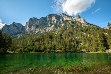 Stunning panorama view of the Green Lake with mountain Pribitz in background on a sunny summer day with blue sky cloud near the village Tragoss, Styria, Austria - obrazy, fototapety, plakaty