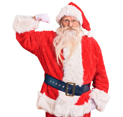 Old senior man with grey hair and long beard wearing traditional santa claus costume strong person...