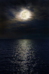 Full moon at night over the sea