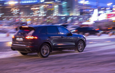 SUV moves at night along the city street