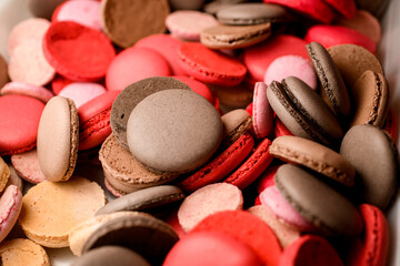 Top view of many colorful macaroon halves