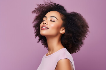 A woman with her eyes closed is wearing a pink shirt