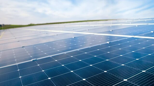 Aerial drone view of blue solar panels installed on a high efficient energy factory roof
