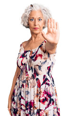 Senior grey-haired woman wearing casual clothes doing stop sing with palm of the hand. warning...