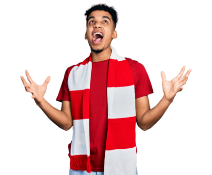 Young african american man football hooligan cheering game crazy and mad shouting and yelling with aggressive expression and arms raised. frustration concept.