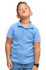 Fototapeta premium Little boy hispanic kid wearing casual clothes looking at the camera blowing a kiss on air being lovely and sexy. love expression.