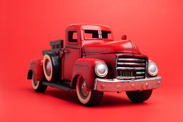 Vintage pickup truck from the 50s, Ford on a red background. toy or model.