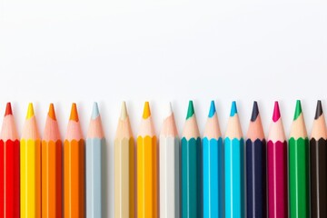 Row of sharpened colored pencils on a white background arranged in a gradient spectrum, a vibrant representation of art tools and creativity.