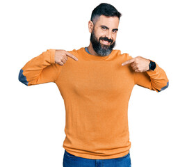 Hispanic man with beard wearing casual winter sweater looking confident with smile on face,...