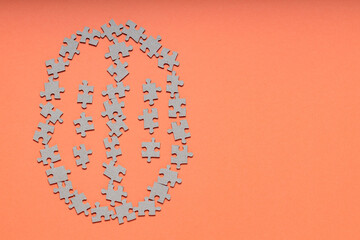 Brain Made of Puzzle Pieces on Orange Background, Copy Space