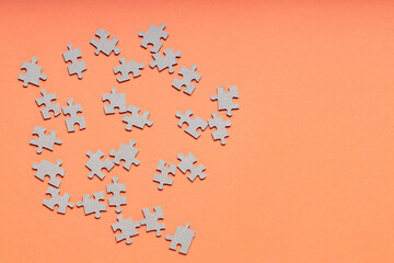 Puzzle with Scattered and Mismatched Puzzle Pieces on an Orange Background, Mental Health...